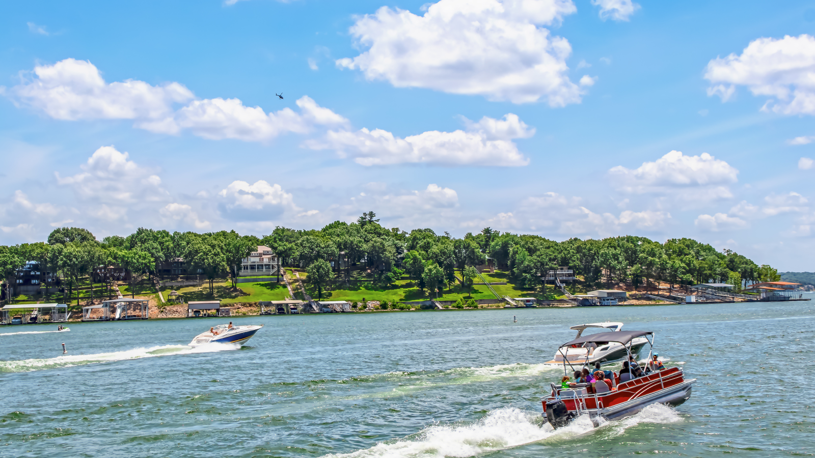 Boats on the lake during a busy summer day.